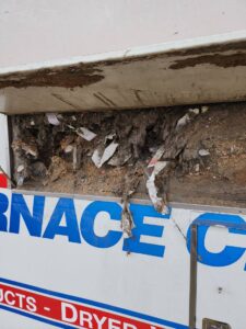 The debris collected over months of cleaning furnaces spilling out of an Alberta Furnace Cleaning truck 
